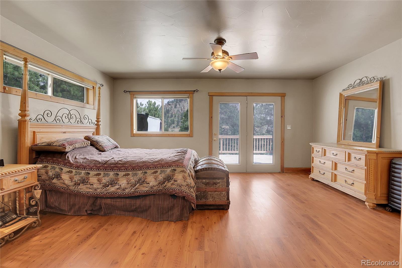 2063 Roland Drive Bailey, CO 80421 - Photo 22 of 49 a bedroom with a bed and wooden floor