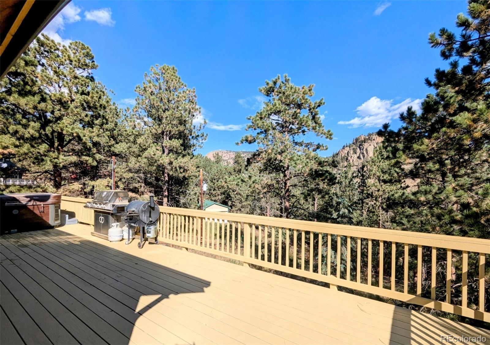 2063 Roland Drive Bailey, CO 80421 - Photo 26 of 49 a balcony with wooden floor and outdoor seating