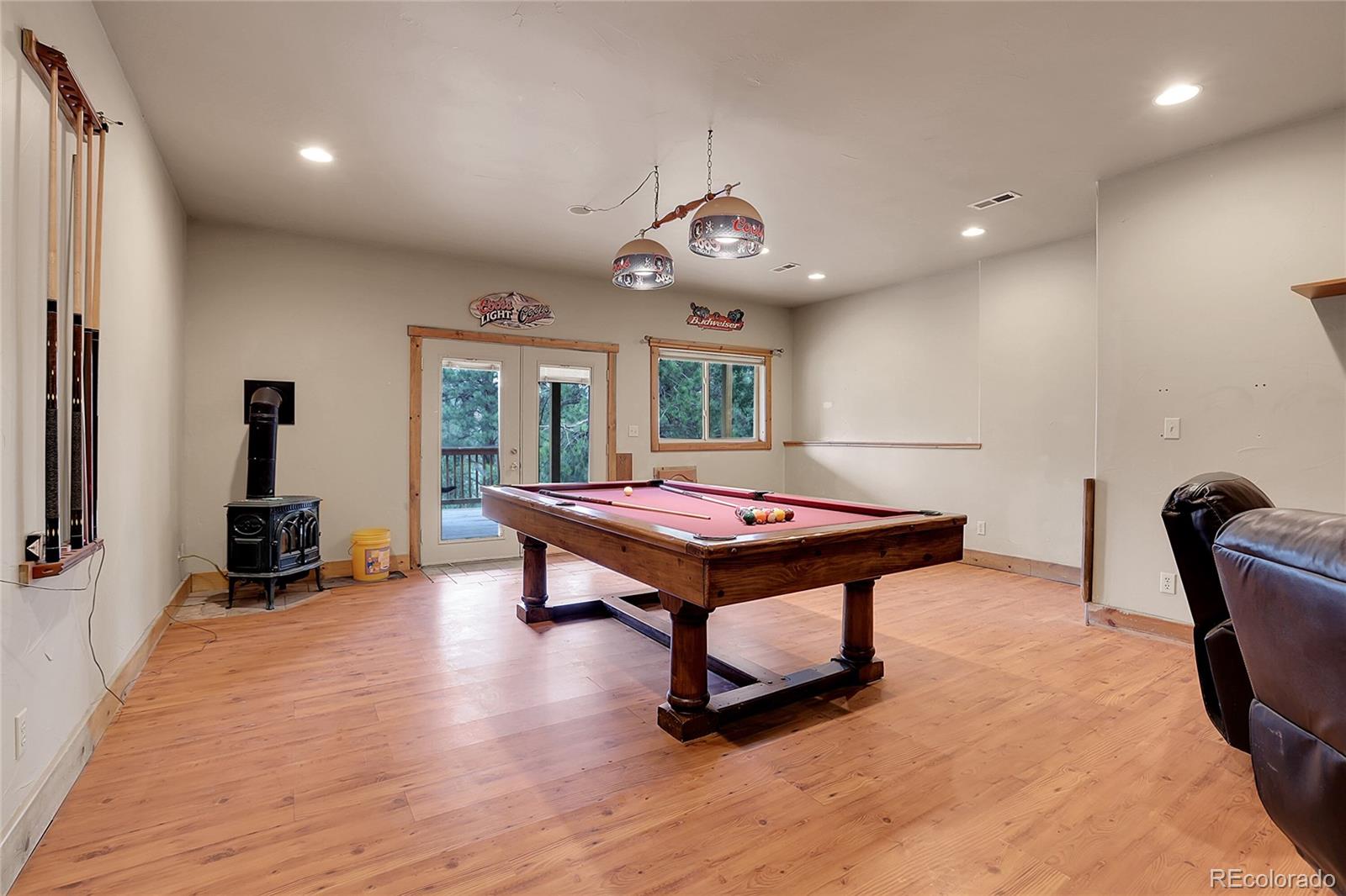 2063 Roland Drive Bailey, CO 80421 - Photo 33 of 49 a living room with furniture a rug and a large window