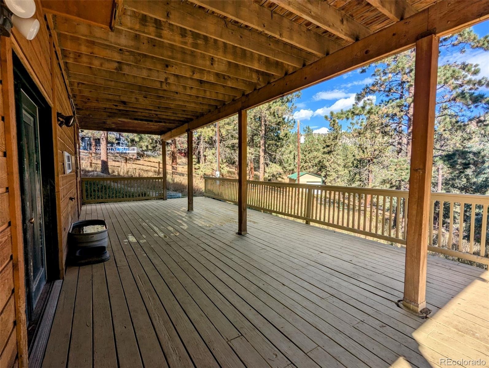2063 Roland Drive Bailey, CO 80421 - Photo 41 of 49 a view of a balcony with wooden floor