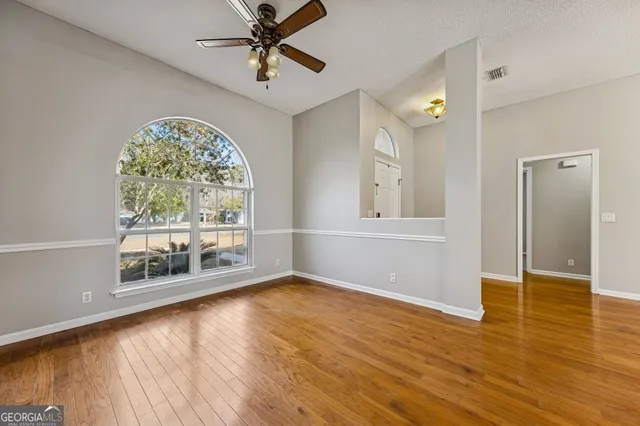 wooden floor in an empty room with a window