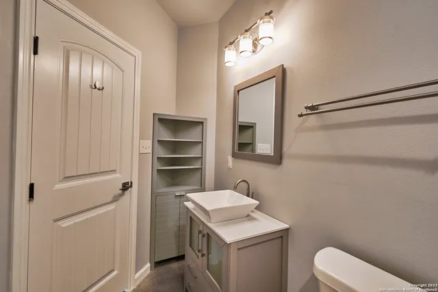 a bathroom with a toilet a sink and mirror