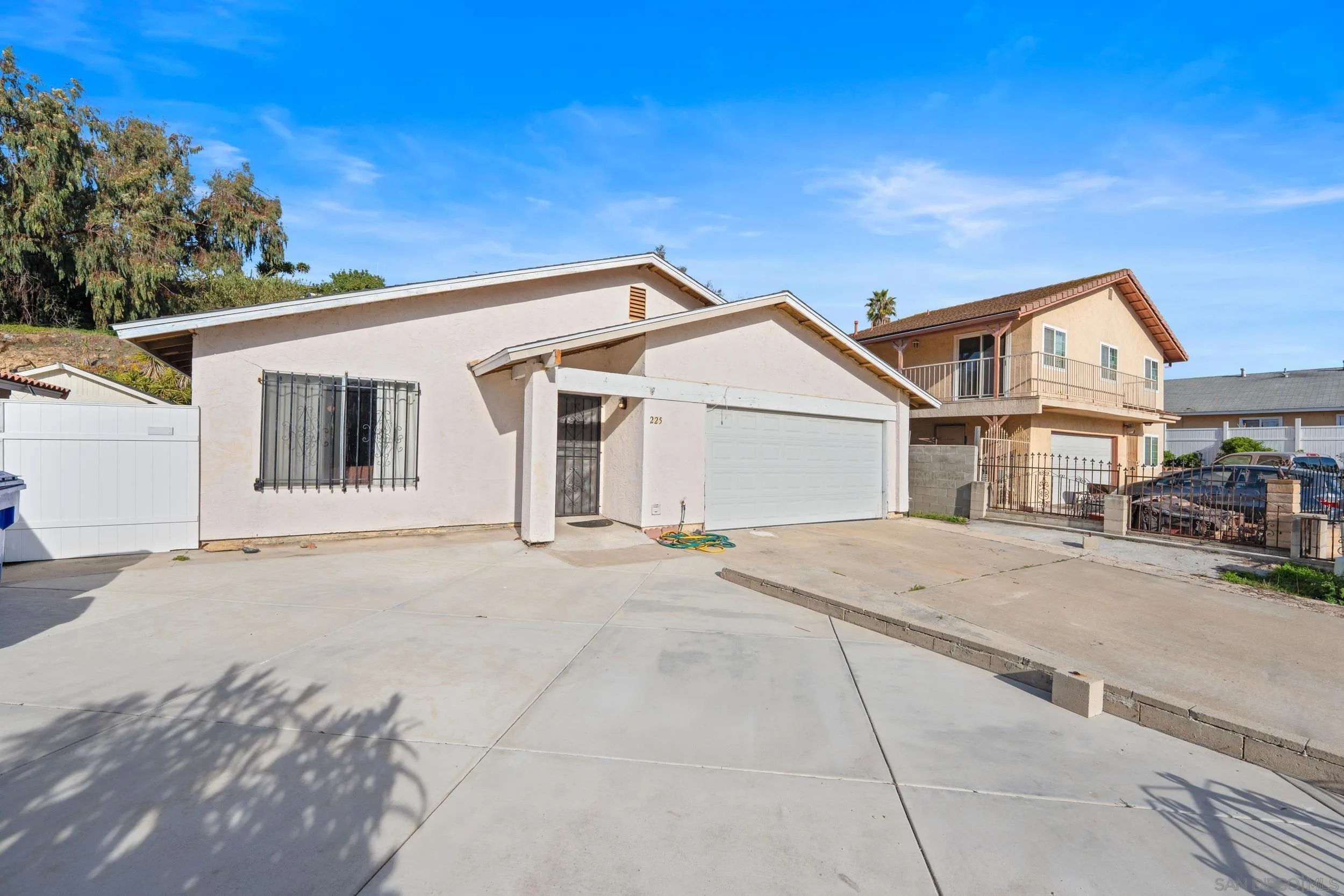 225 Deep Dell Road San Diego, CA 92114 - Photo 1 of 17 a view of a white house with a outdoor space