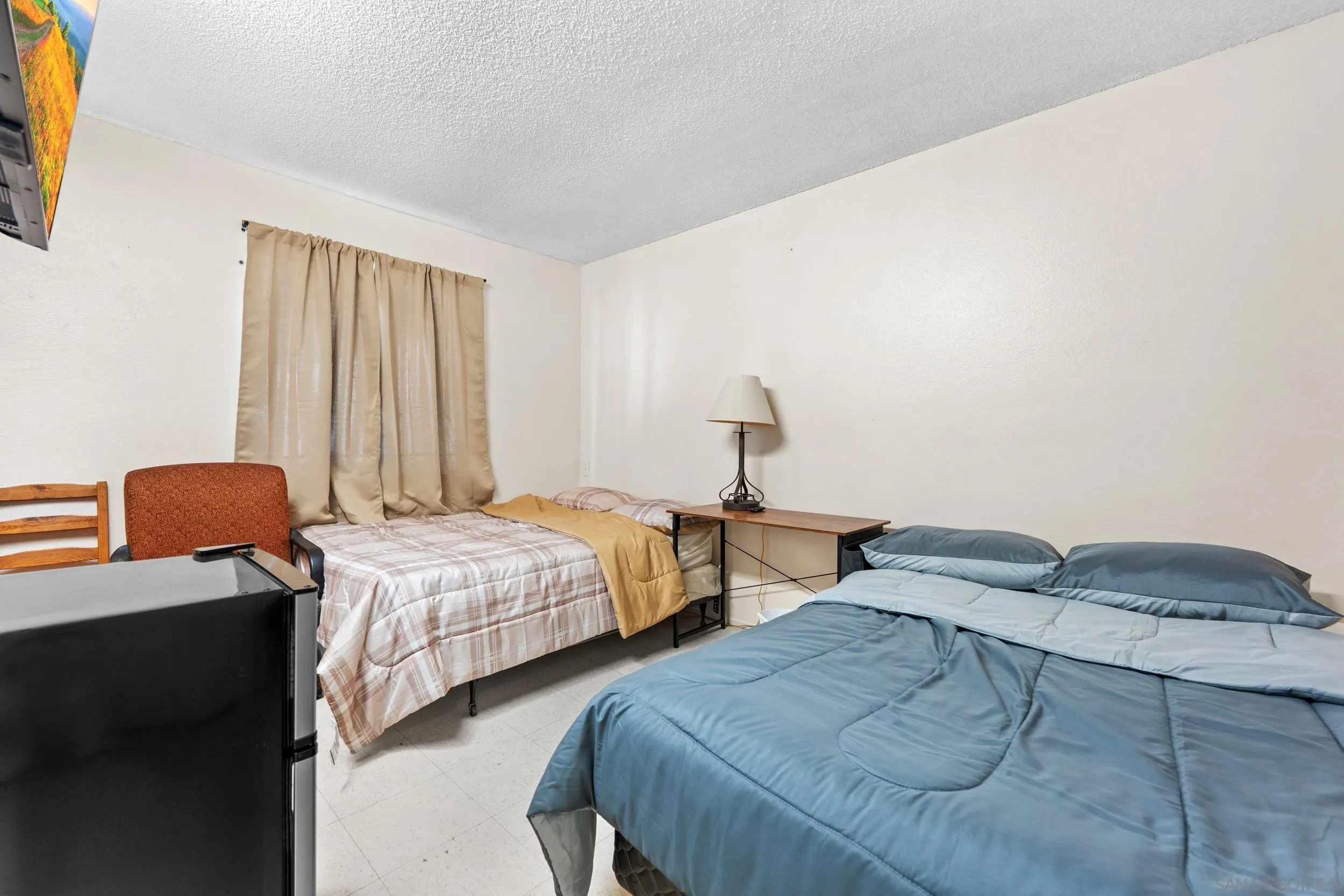 225 Deep Dell Road San Diego, CA 92114 - Photo 11 of 17 a bedroom with two beds and a lamp