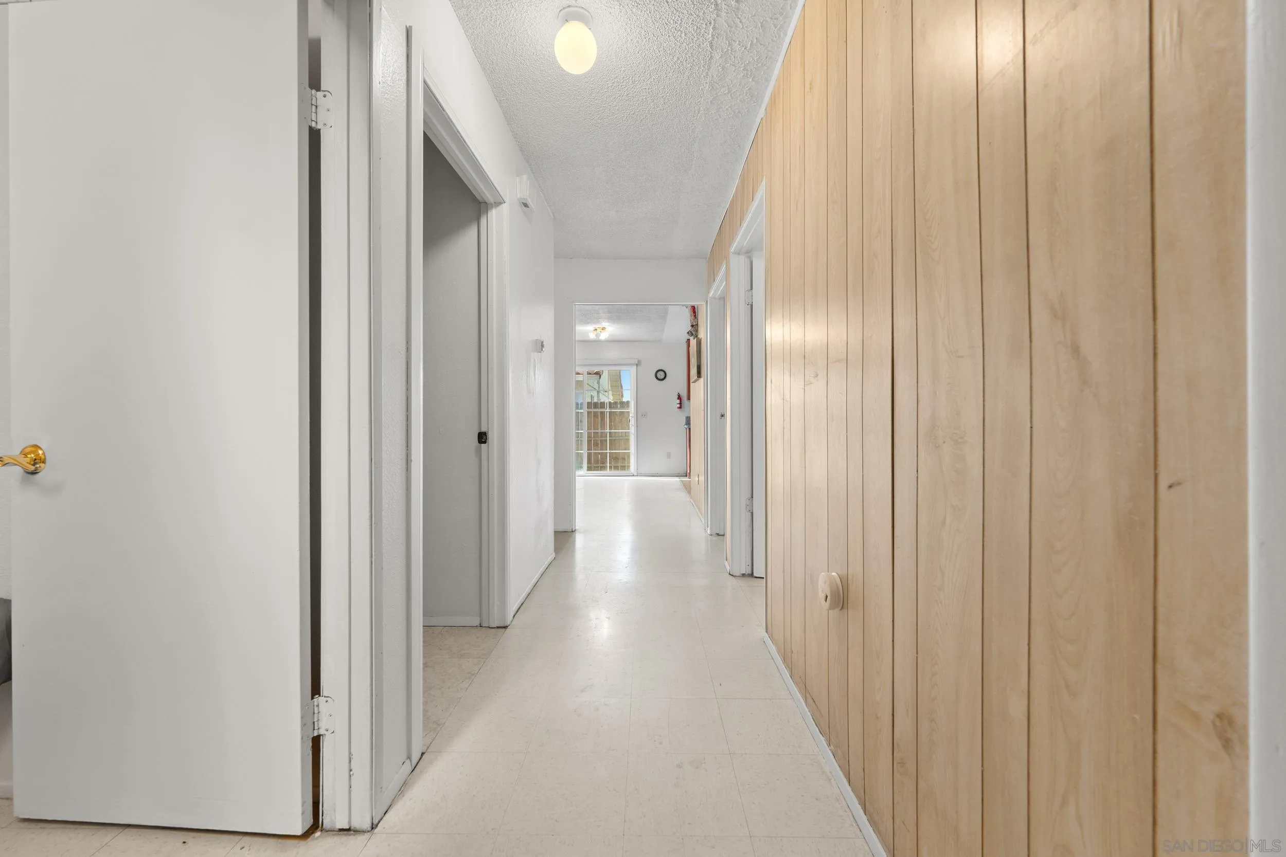225 Deep Dell Road San Diego, CA 92114 - Photo 16 of 17 a view of a hallway with wooden floor