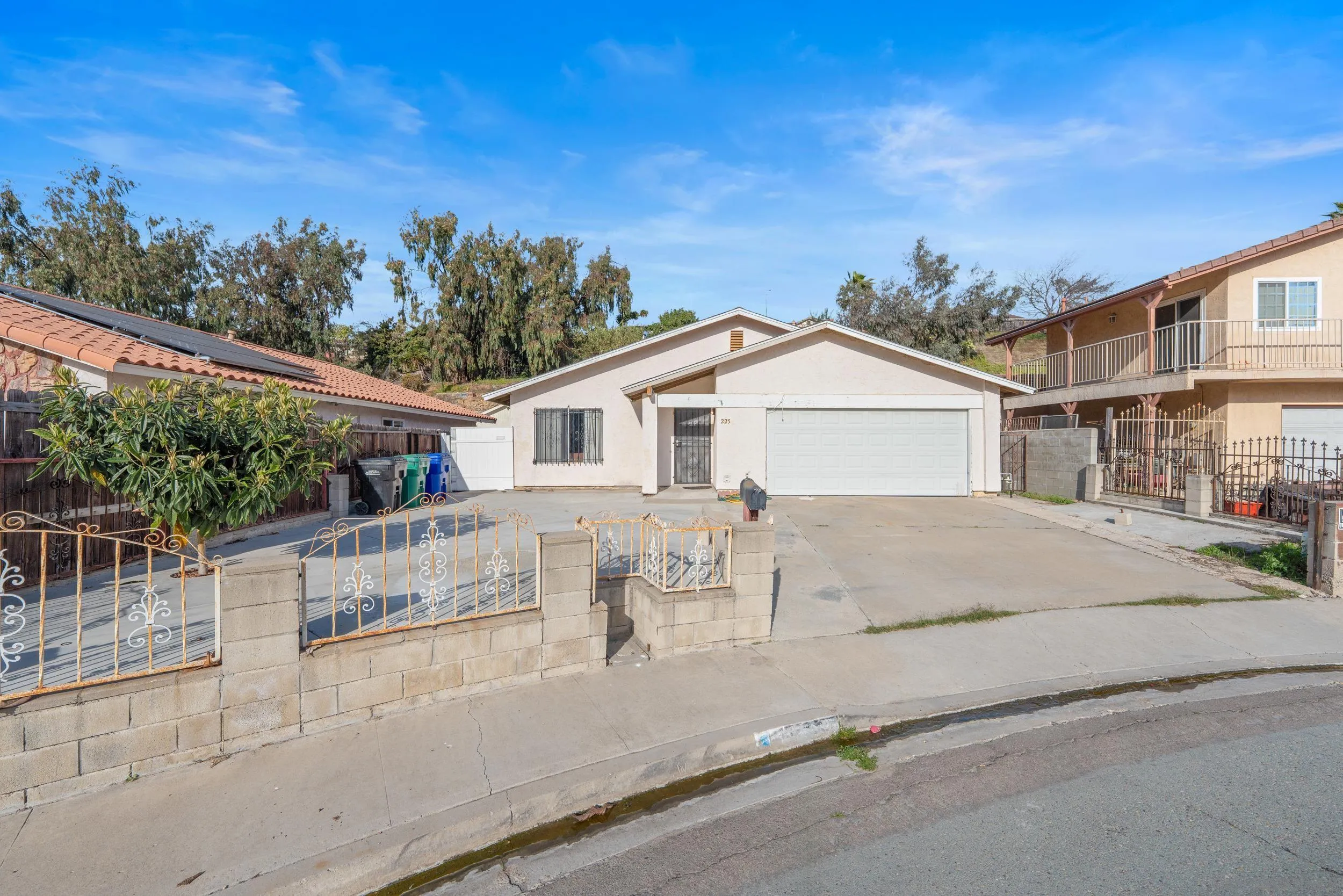 225 Deep Dell Road San Diego, CA 92114 - Photo 2 of 17 a view of a white house with a large windows and plants