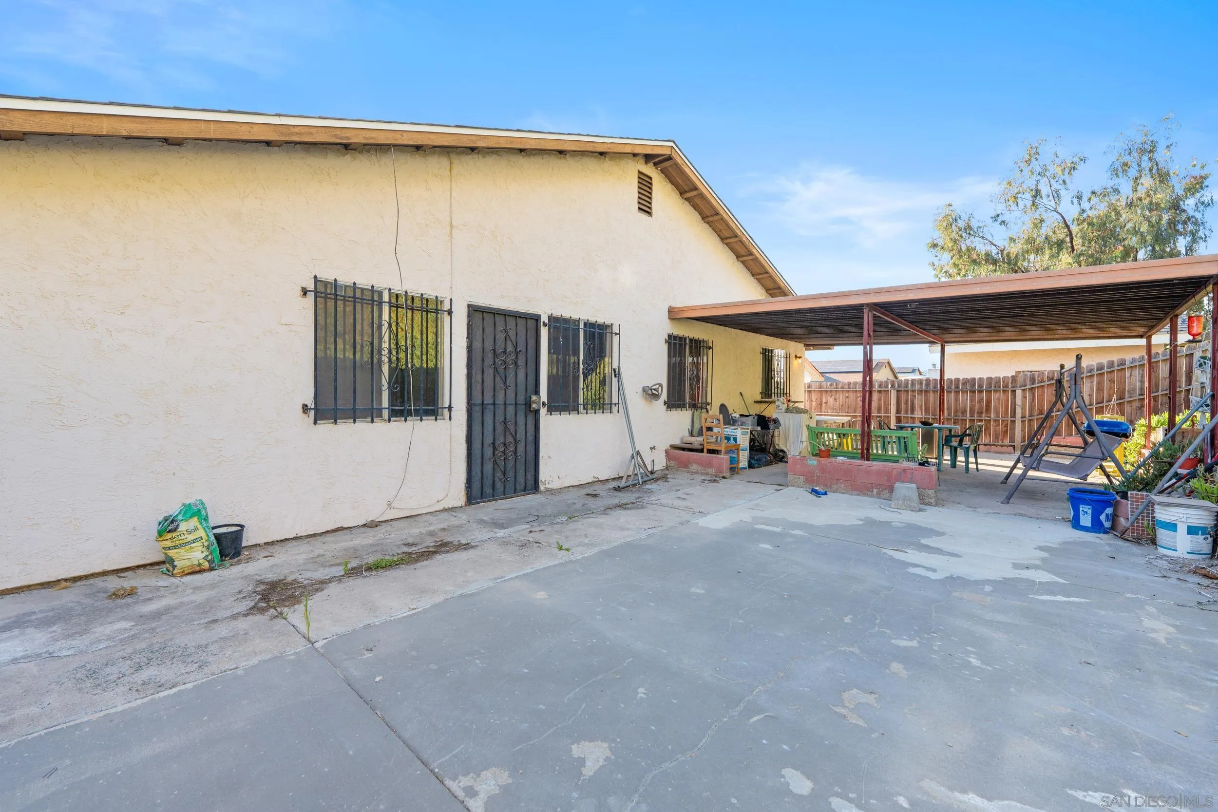 225 Deep Dell Road San Diego, CA 92114 - Photo 3 of 17 a backyard of a house with table and chairs