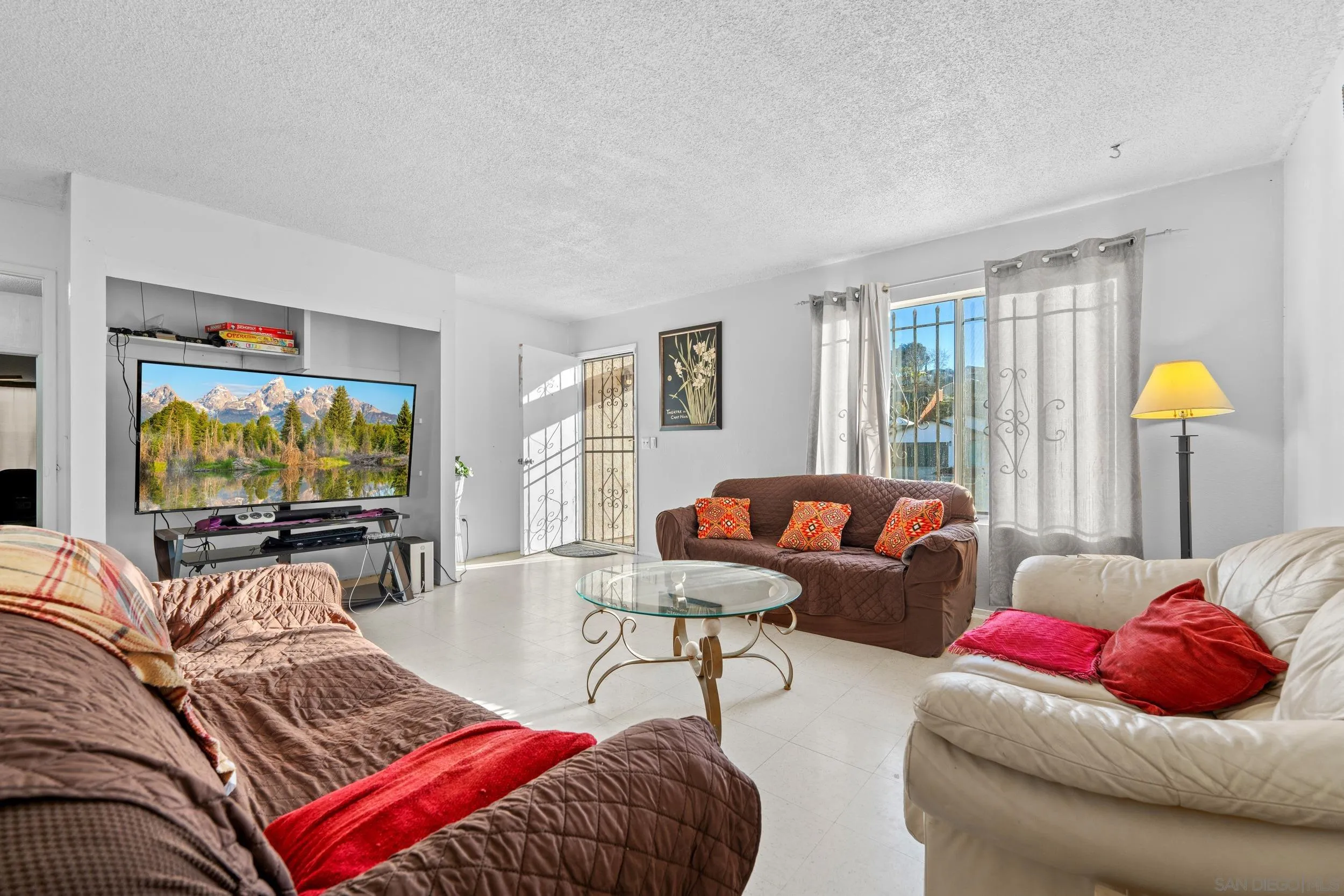 225 Deep Dell Road San Diego, CA 92114 - Photo 4 of 17 a living room with furniture a lamp and a flat screen tv
