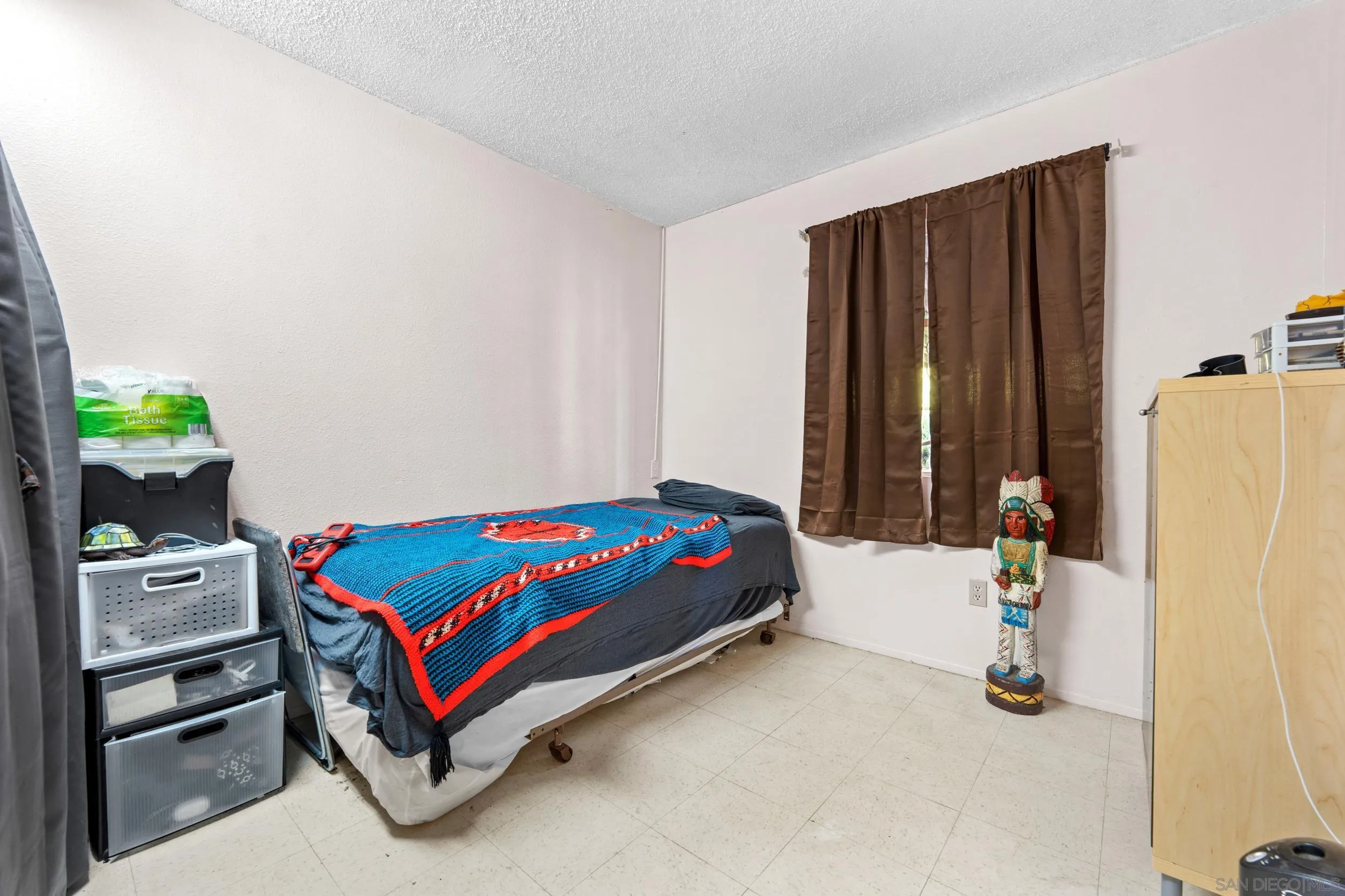 225 Deep Dell Road San Diego, CA 92114 - Photo 9 of 17 a bedroom with a bed and a window