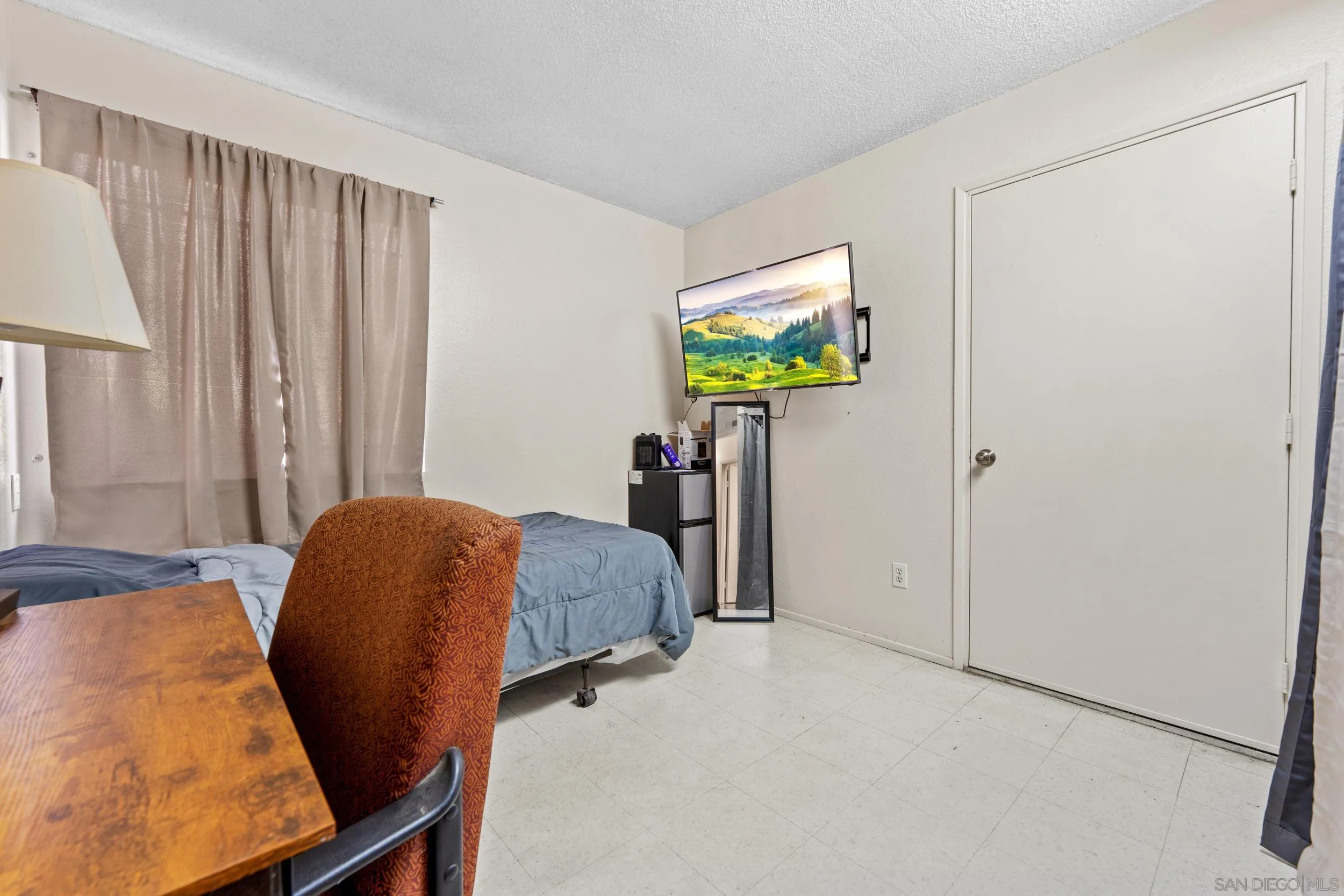 225 Deep Dell Road San Diego, CA 92114 - Photo 10 of 17 a bedroom with a bed and a desk