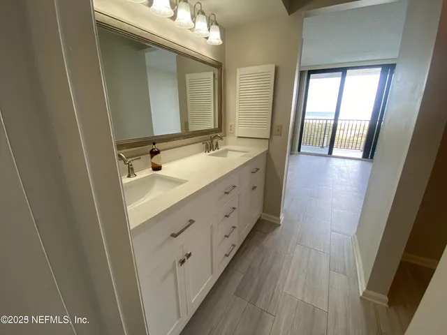 a bathroom with a double vanity sink and mirror