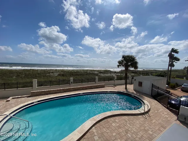 a view of a swimming pool and a back yard