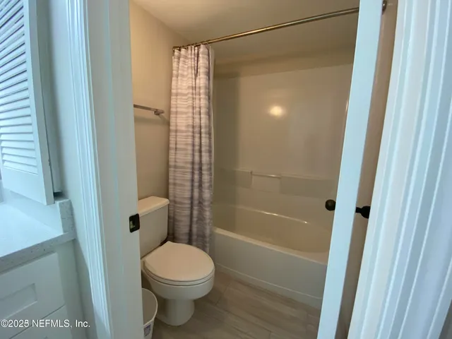 a bathroom with a shower and a toilet