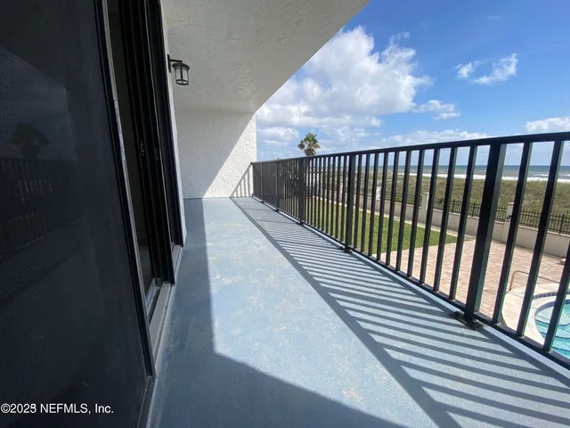 a view of balcony with wooden floor