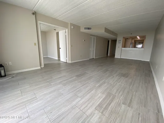 a view of an empty room and a window