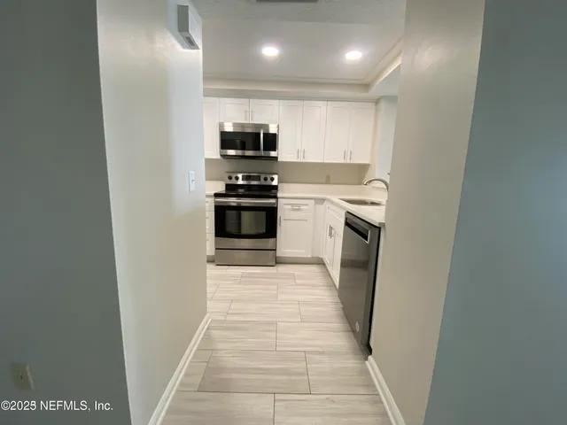 a kitchen with stainless steel appliances a refrigerator and a stove