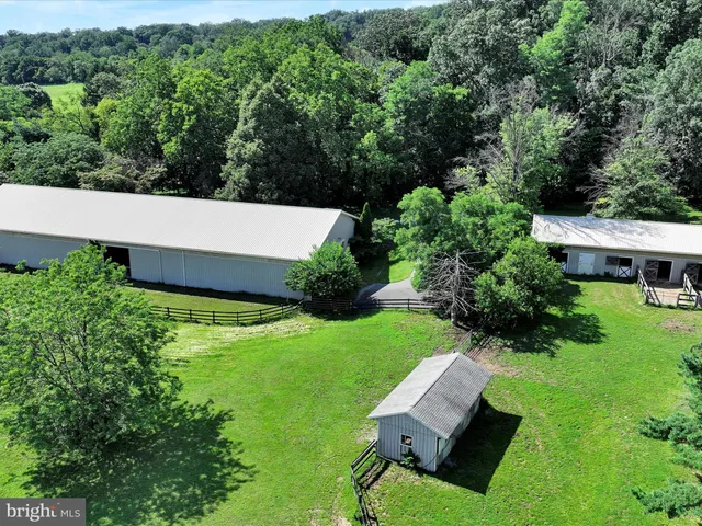 an aerial view of a house with pool garden and outdoor seating