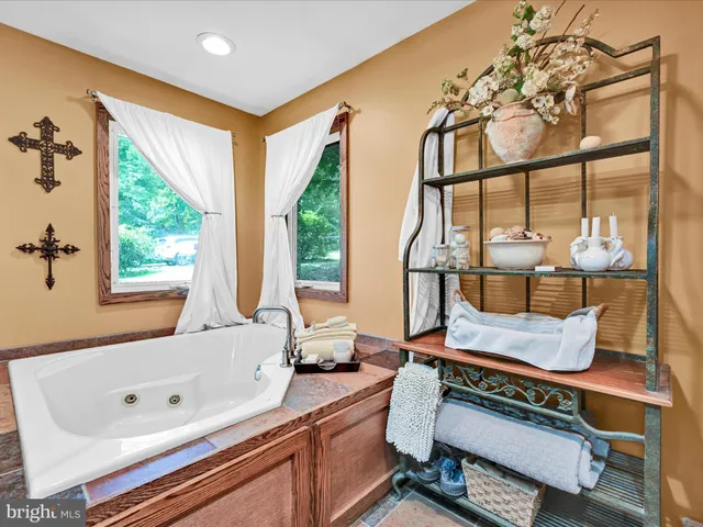 a bathroom with a granite countertop sink a large mirror and a shower