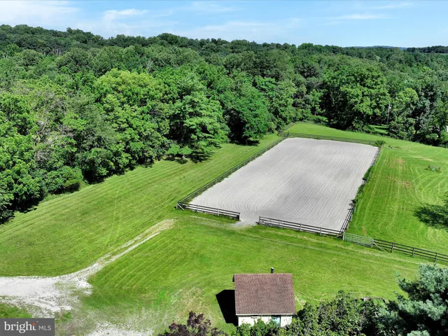 an aerial view of a house with a yard and lake view