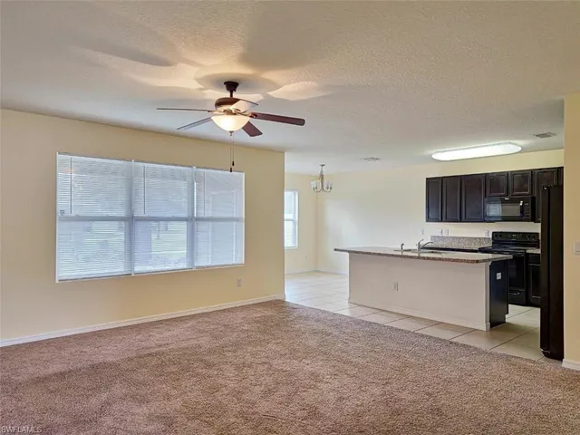 a view of a kitchen with a sink and a window