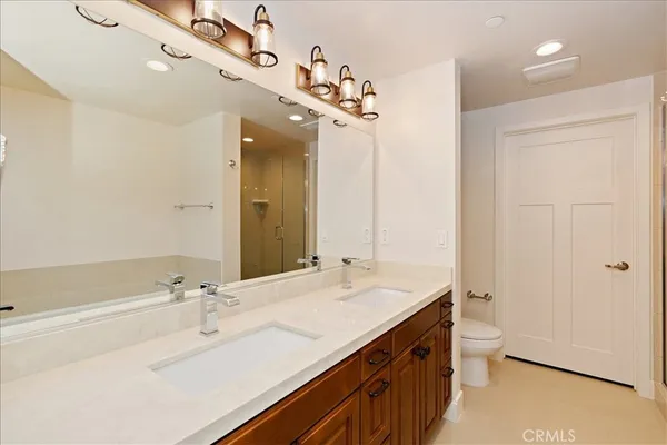 a spacious bathroom with a double vanity sink mirror and toilet