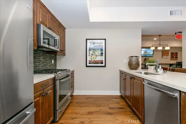 a kitchen with stainless steel appliances granite countertop a stove and a sink