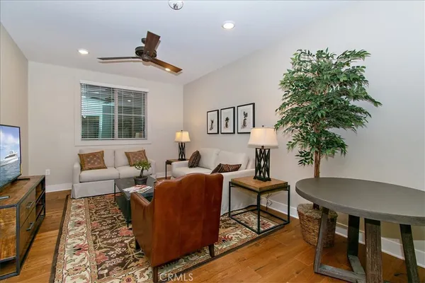 a living room with furniture a window and a potted plant