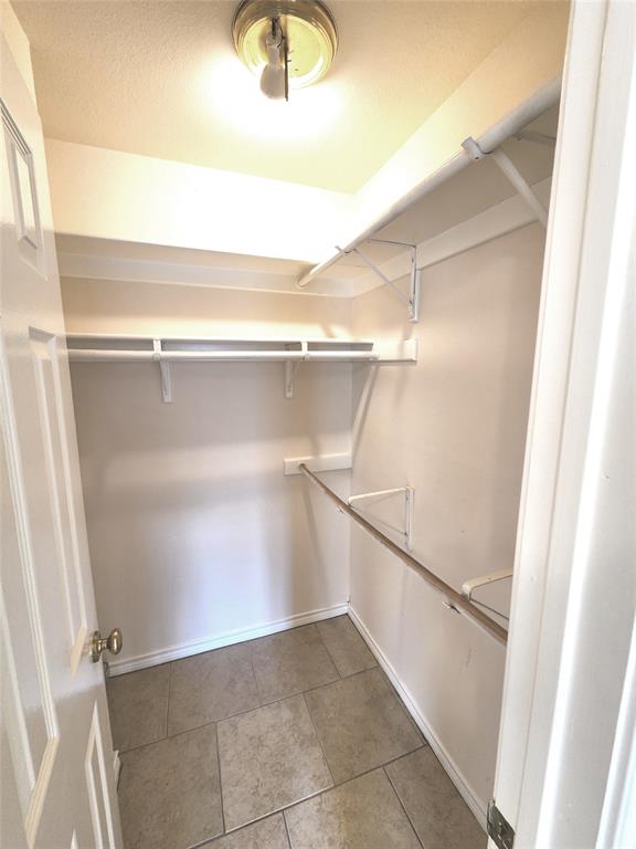 8811 Clearbrook Trail Austin, TX 78729 - Photo 14 of 38 lft A - Functional closet offers ample storage with built-in shelving and hanging rods.