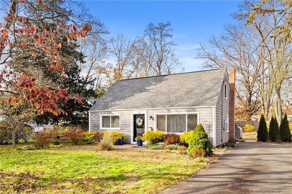 97 Douglas Road Glastonbury, CT 06033 - Photo 1 of 1 a front view of house with outdoor seating and covered with trees