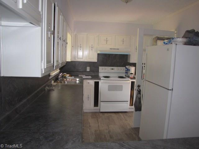 4596 Shady Grove Road Providence, NC 27315 - Photo 8 of 23 New flooring, counters, backsplash, paint, stove and vent hood.