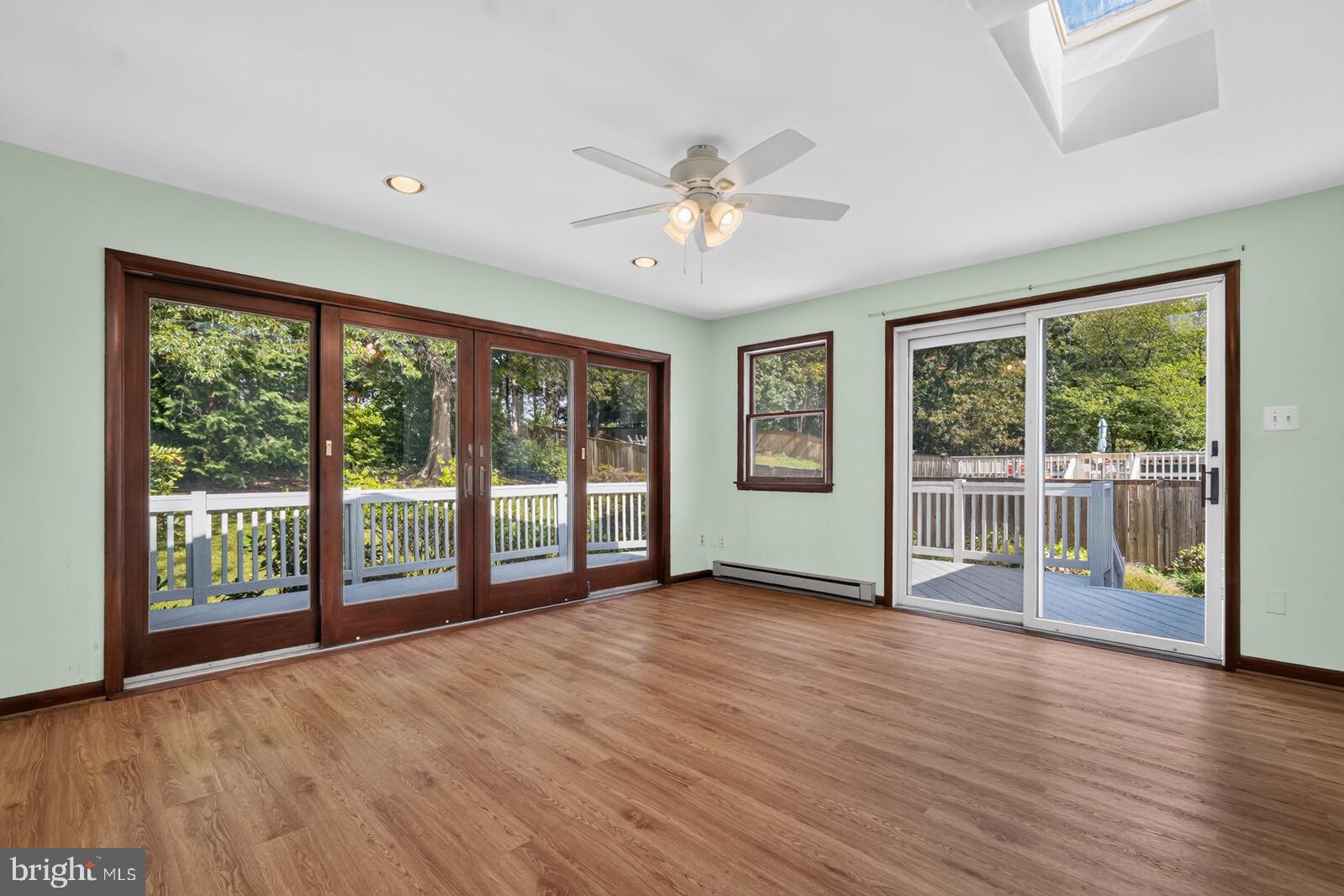 204 Rolling Road Gaithersburg, MD 20877 - Photo 15 of 53 Two sets of doors lead to deck from sunroom.