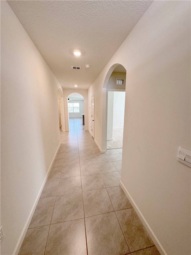 1836 Barber Street Sebastian, FL 32958 - Photo 9 of 29 a view of a hallway with wooden floor and a bathroom sink