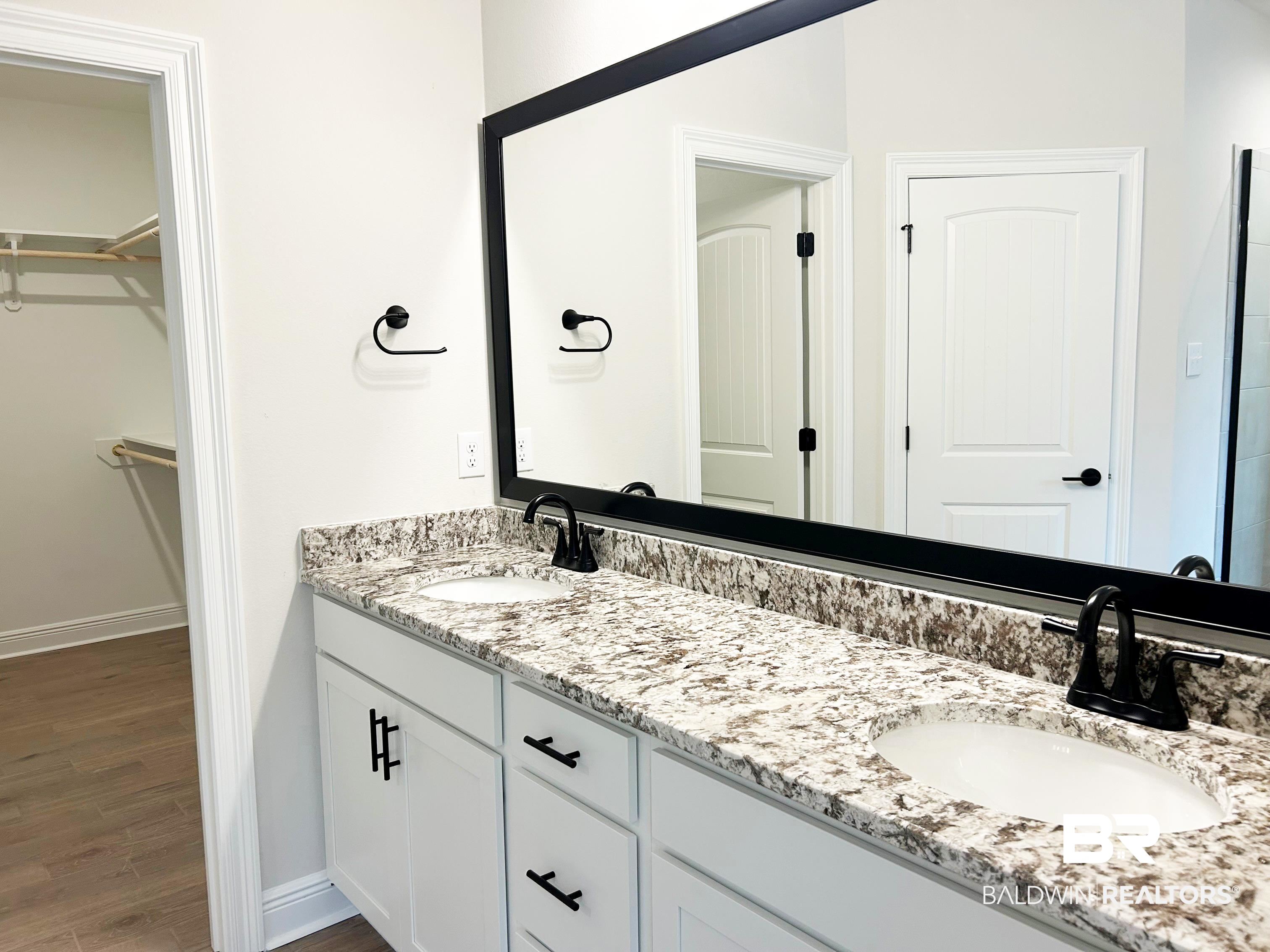 873 Sumter Loop Foley, AL 36535 - Photo 18 of 26 Bathroom with double vanity, dark wood finished floors, and a spacious closet
