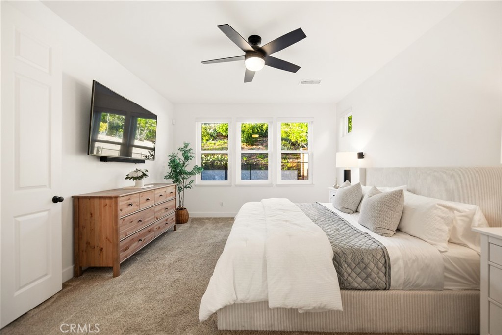 14431 Shawnee Street Moorpark, CA 93021 - Photo 20 of 72 a spacious bedroom with a large bed and a flat screen tv