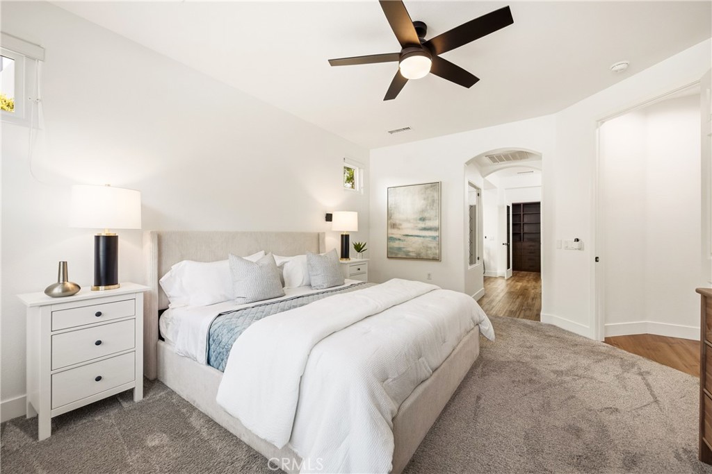 14431 Shawnee Street Moorpark, CA 93021 - Photo 21 of 72 a spacious bedroom with a bed and a chandelier