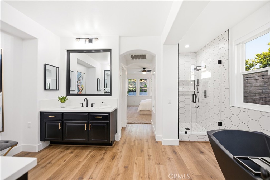 14431 Shawnee Street Moorpark, CA 93021 - Photo 22 of 72 a spacious bathroom with a bathtub double vanity sink and mirror