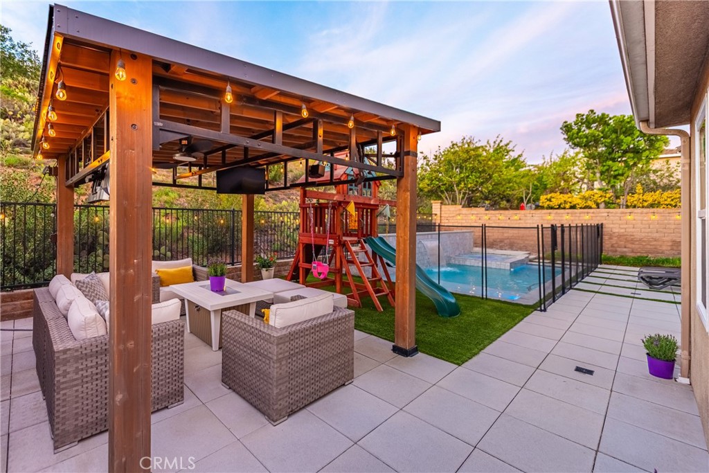 14431 Shawnee Street Moorpark, CA 93021 - Photo 50 of 72 a living room with patio furniture and a floor to ceiling window