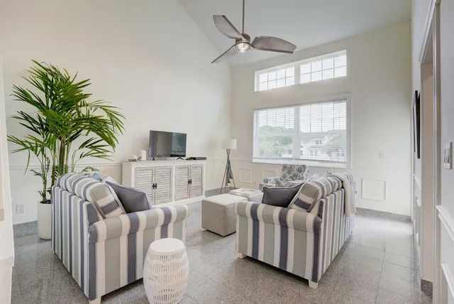 a living room with furniture potted plant and a lamp