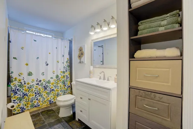 a bedroom with two beds and wooden floor