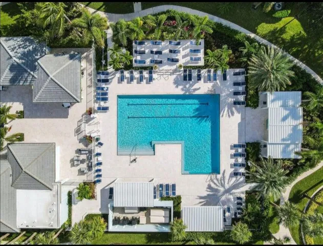 a view of a swimming pool with outdoor seating