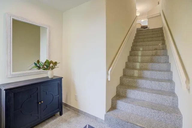 a view of a dining room with furniture and chandelier