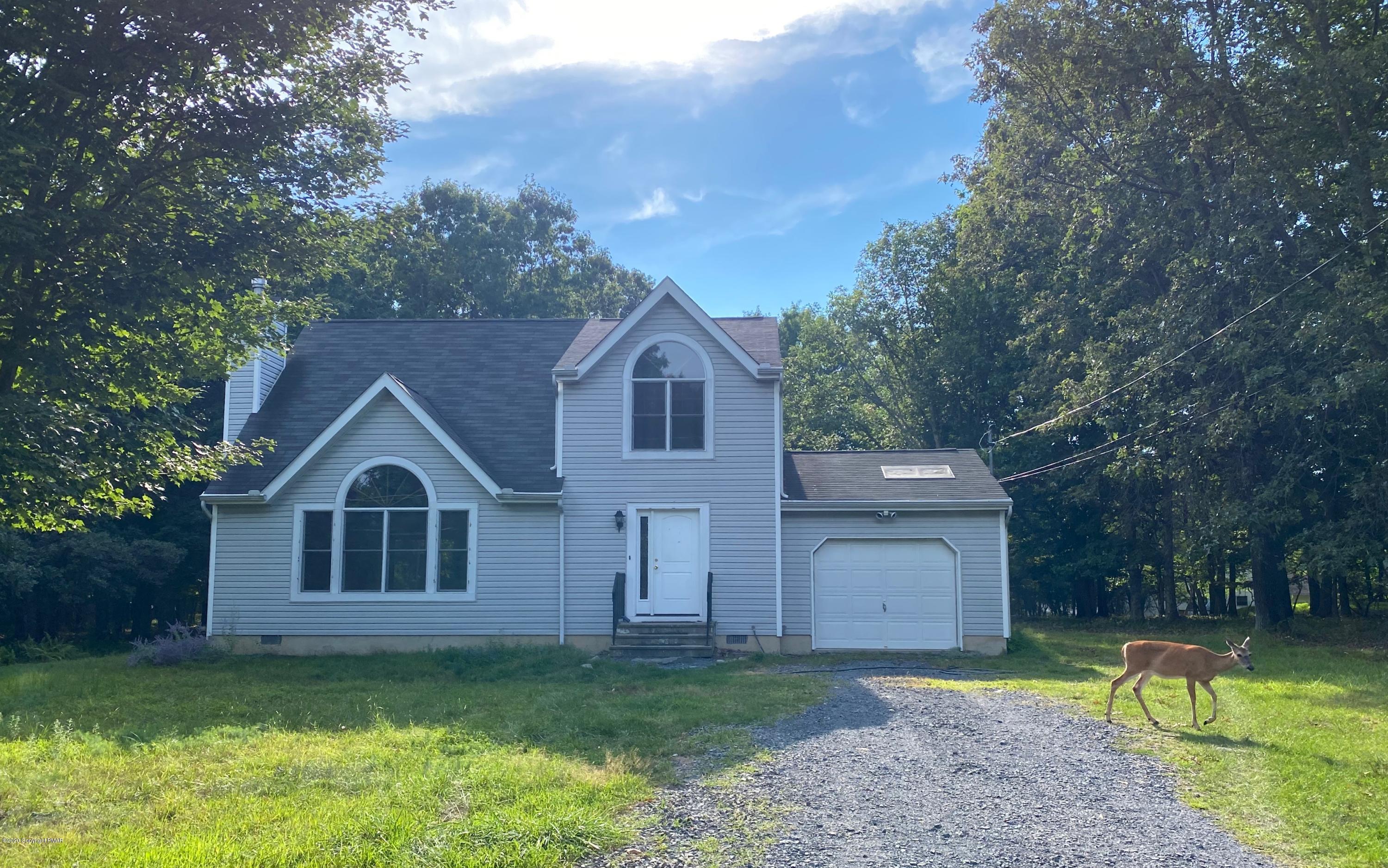 2166 Valleyview Drive Bushkill, PA 18324 - Photo 1 of 18 a view of a big house with a big yard and large trees