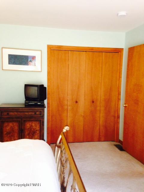 2166 Valleyview Drive Bushkill, PA 18324 - Photo 12 of 18 a bedroom with a bed and a flat screen tv