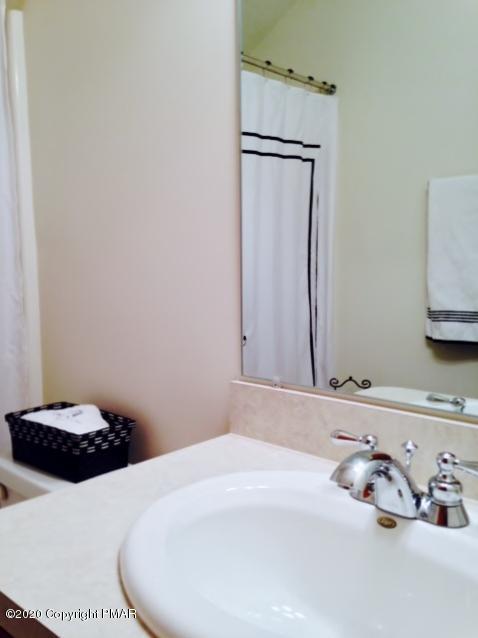 2166 Valleyview Drive Bushkill, PA 18324 - Photo 16 of 18 a bathroom with a sink and a mirror