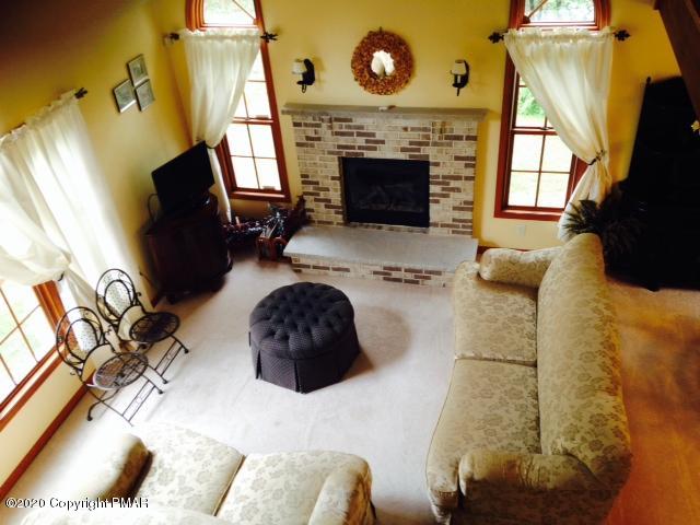 2166 Valleyview Drive Bushkill, PA 18324 - Photo 5 of 18 a living room with furniture and a fireplace