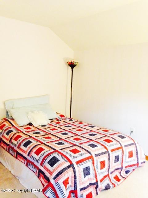 2166 Valleyview Drive Bushkill, PA 18324 - Photo 7 of 18 a bedroom with a bed and a night stand