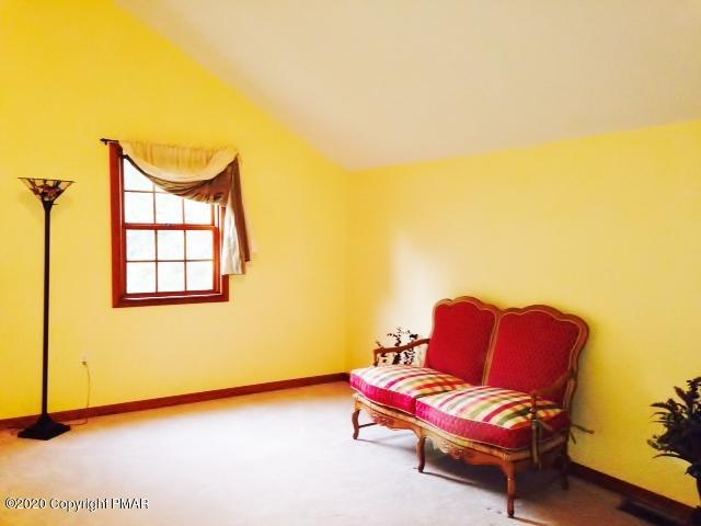 2166 Valleyview Drive Bushkill, PA 18324 - Photo 8 of 18 a backyard with a couch and a potted plant