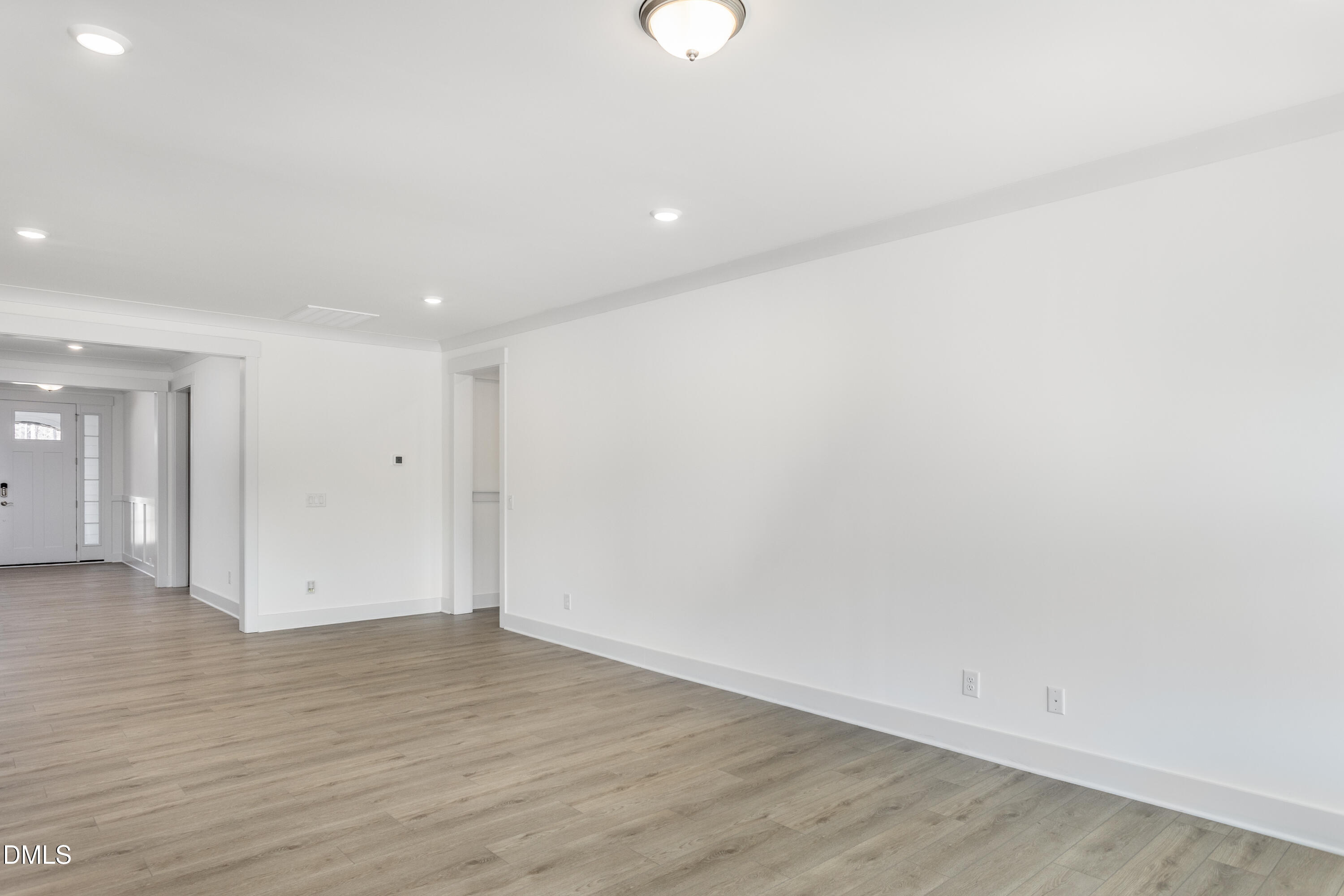 70 Slippery Elm Road Youngsville, NC 27596 - Photo 7 of 32 an empty room with wooden floor and windows