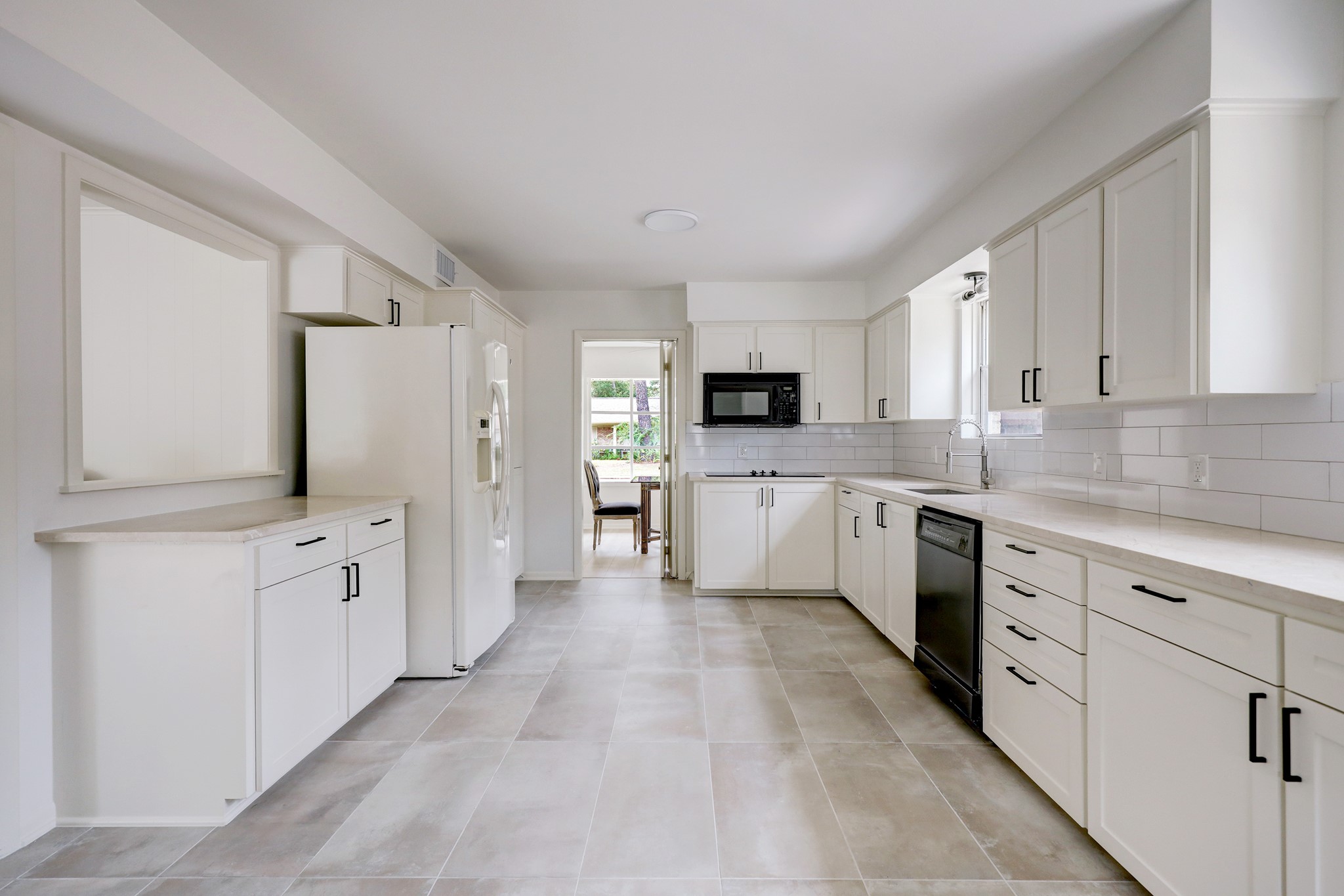 1810 Nocturne Lane Houston, TX 77043 - Photo 12 of 32 a large white kitchen with cabinets