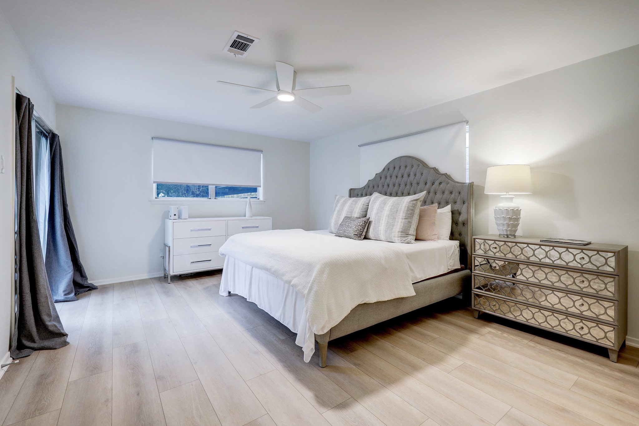 1810 Nocturne Lane Houston, TX 77043 - Photo 17 of 32 a bedroom with a bed a mirror and gym equipment